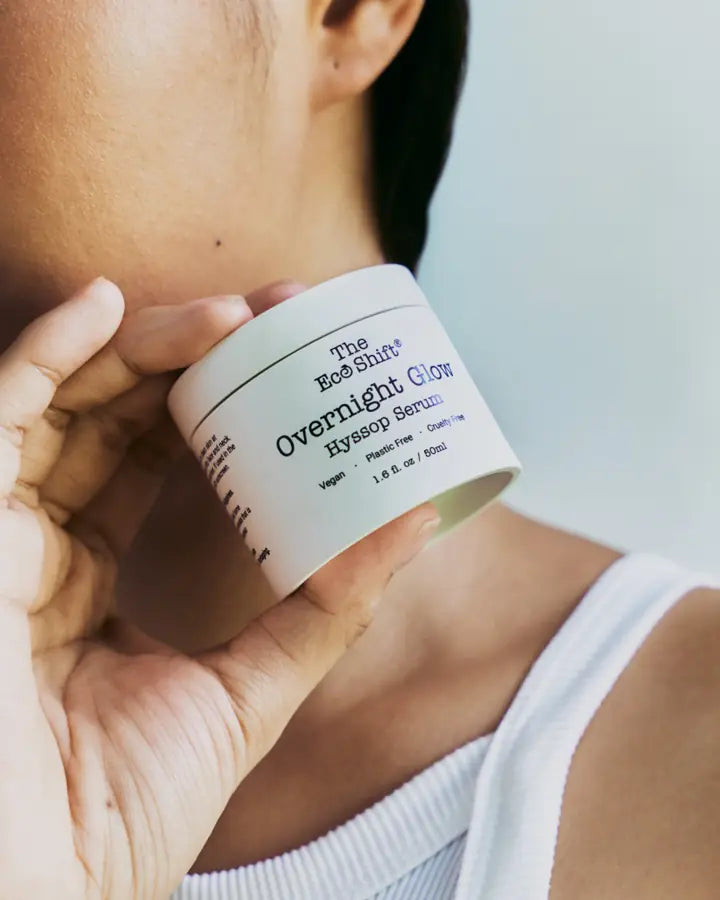 Overnight Glow Hyssop Serum held against the neck