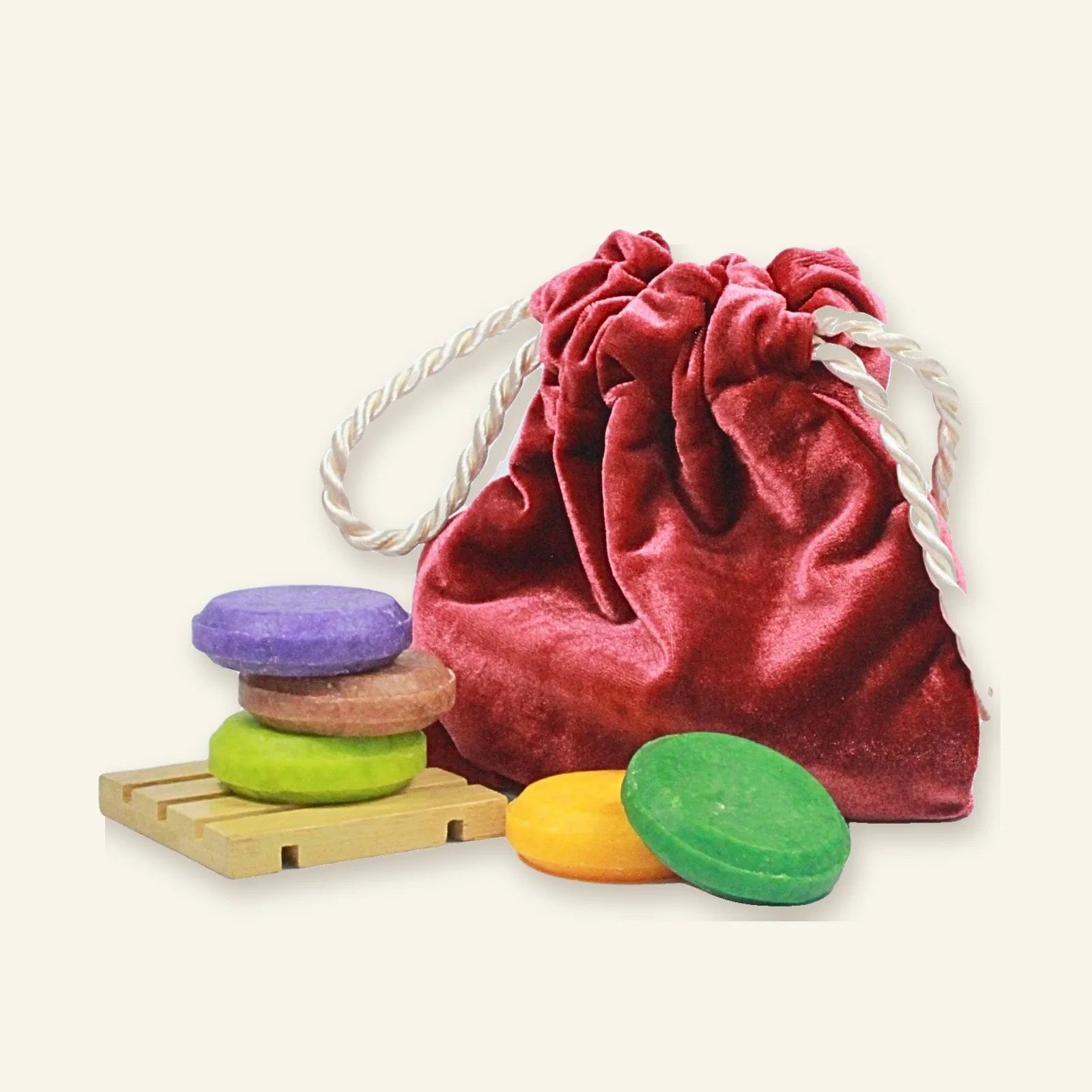 Mini shampoo bars with a red velvet pouch
